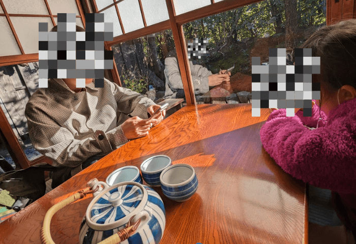 2024年1月2日の年始の実際の画像。
京都市の今宮神社参道であぶり餅を提供しているお店「一和」の店内の画像。
座敷のテーブルの上にお茶があり、父親と6歳の女の子が座っている。